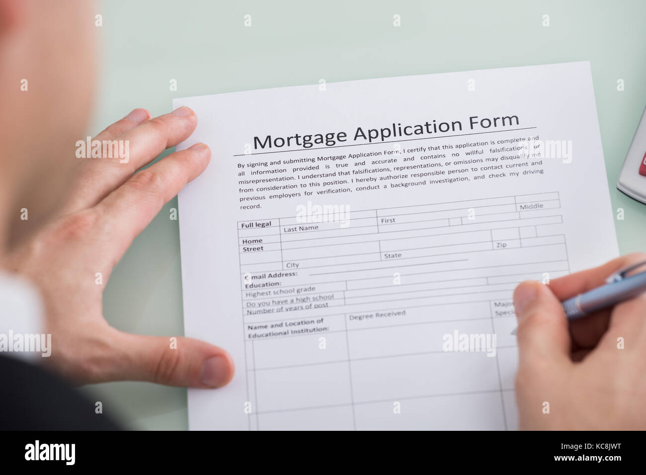 Closeup Of Person Hand Over Mortgage Application Form Stock Photo Alamy