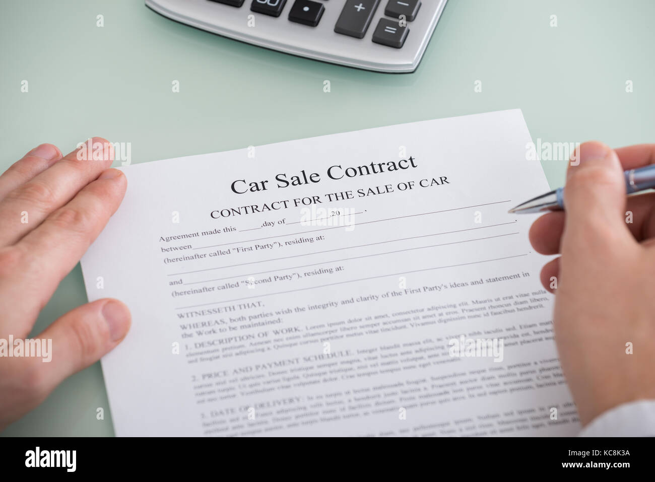 Close-up Of A Person Filling Car Sale Contract Form Stock Photo