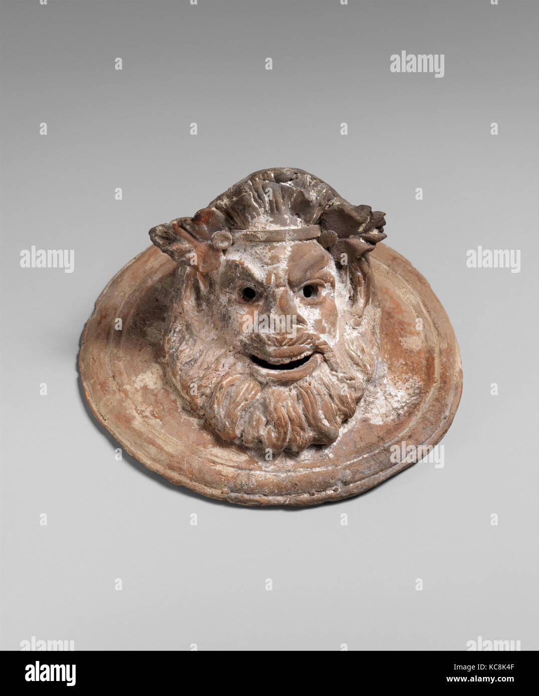 Terracotta roundel with mask of Pan, 1st century B.C Stock Photo