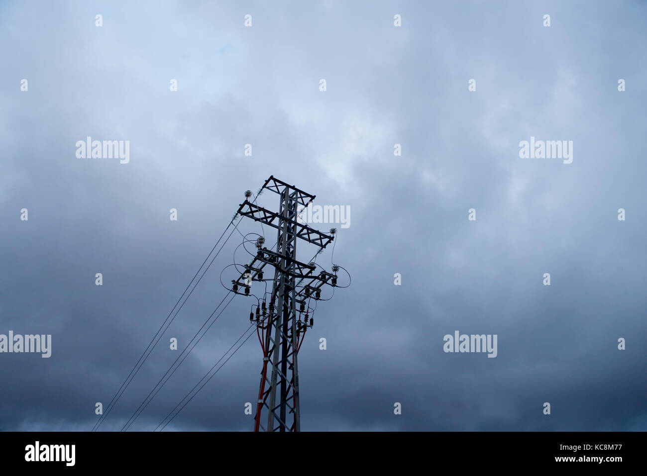 Low angle of electrical supply unit against storm clouds Stock Photo