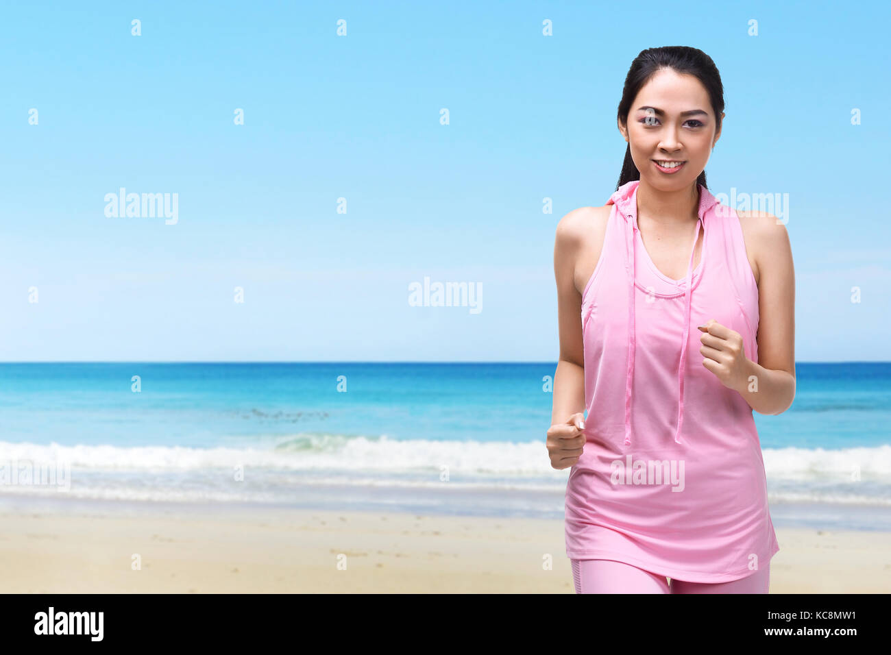 Young asian woman with sportswear running on the beach Stock Photo Alamy