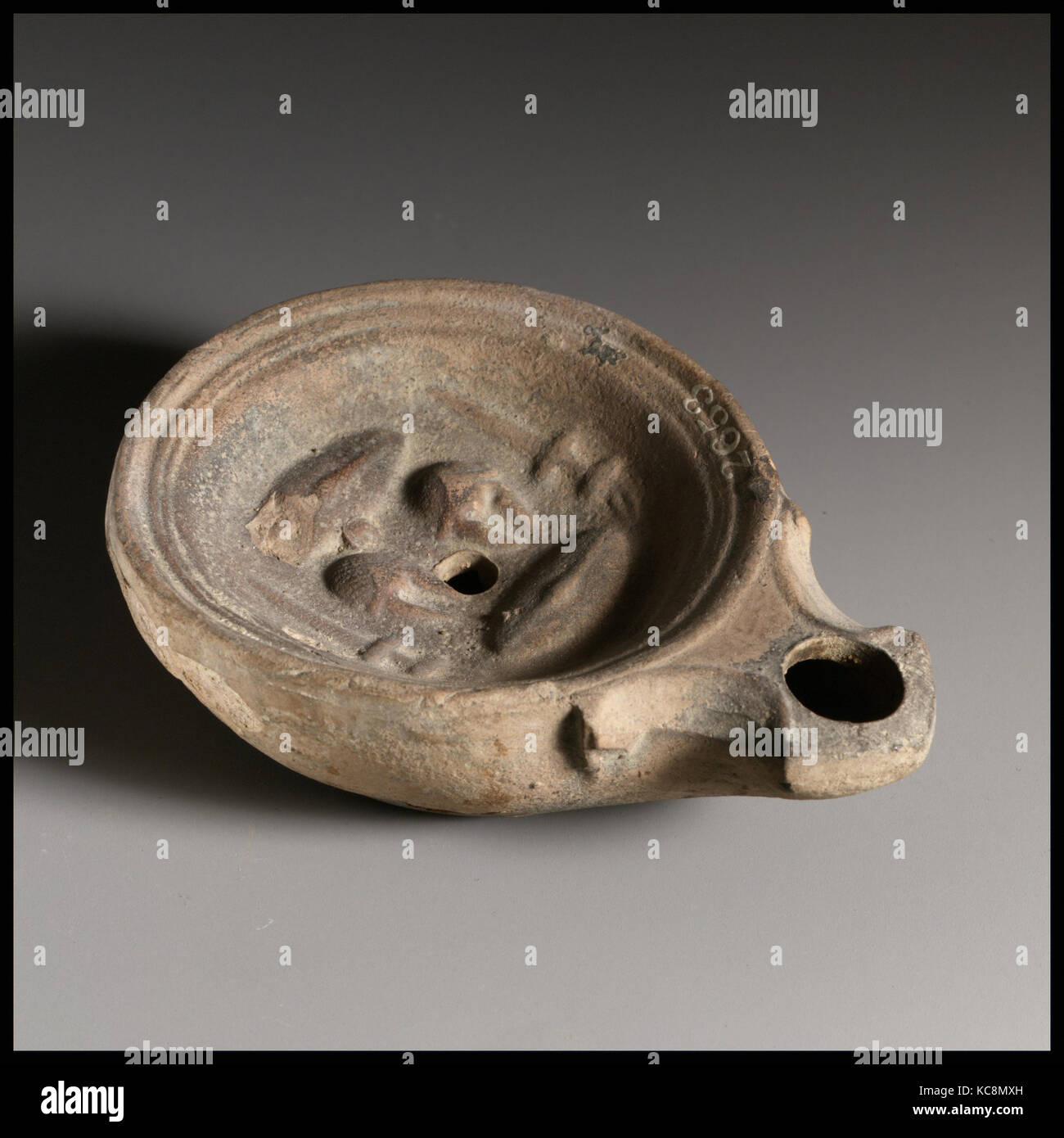Terracotta lamp with military equipment, mid-1st century A.D Stock Photo