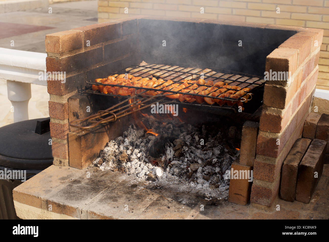 Cooking meat on a Bar-B-Que outdoors Stock Photo