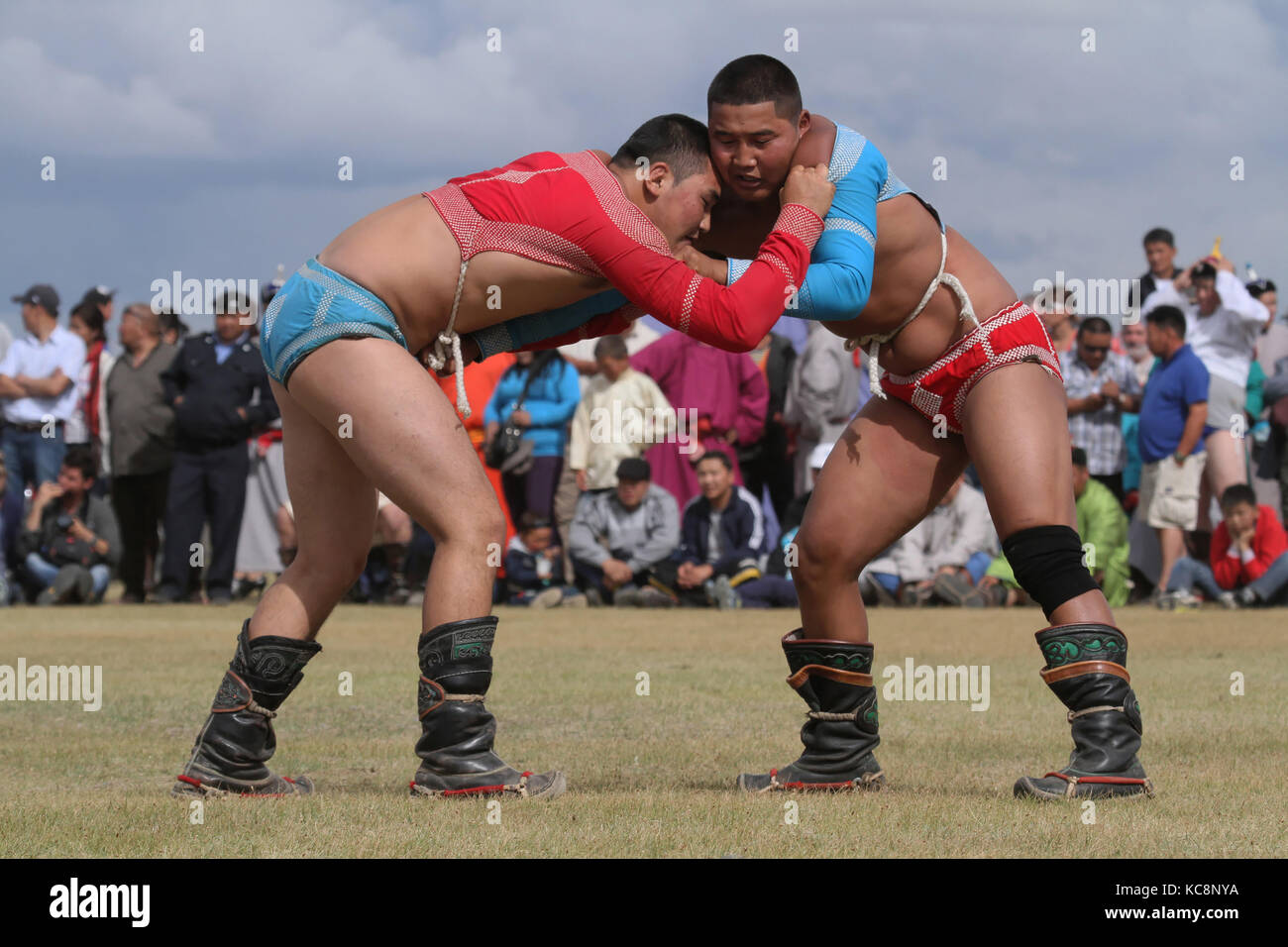 KHARKHORIN, MONGOLIA, JULY, 8 - Mongolian wrestling during Naadam midsummer festival, on July 8, 2013 in Kharkhorin, Mongolia. Naadam is inscribed on  Stock Photo