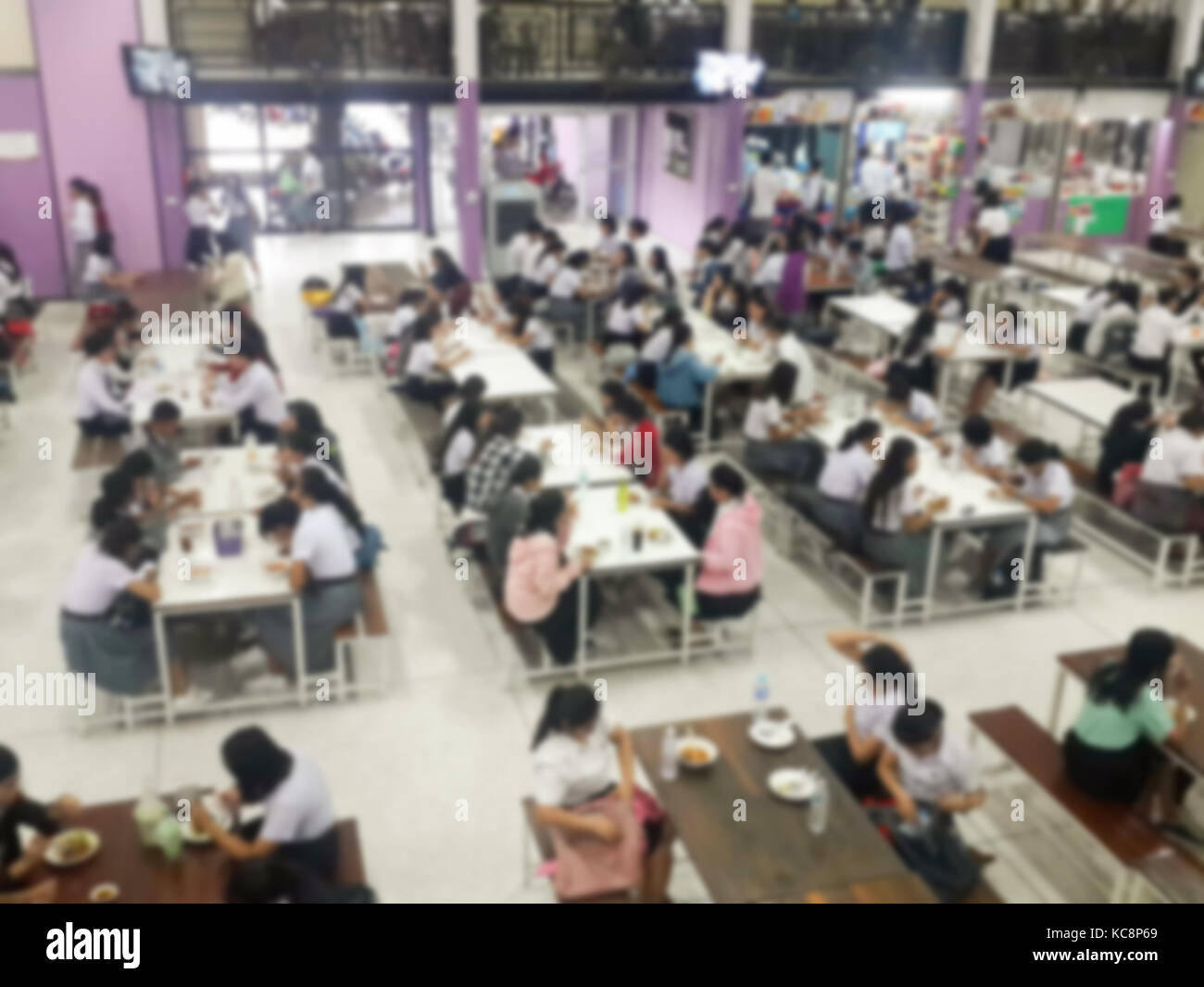 Blur image Canteen Dining Hall Room, A lot of people are eating food in University canteen blur
