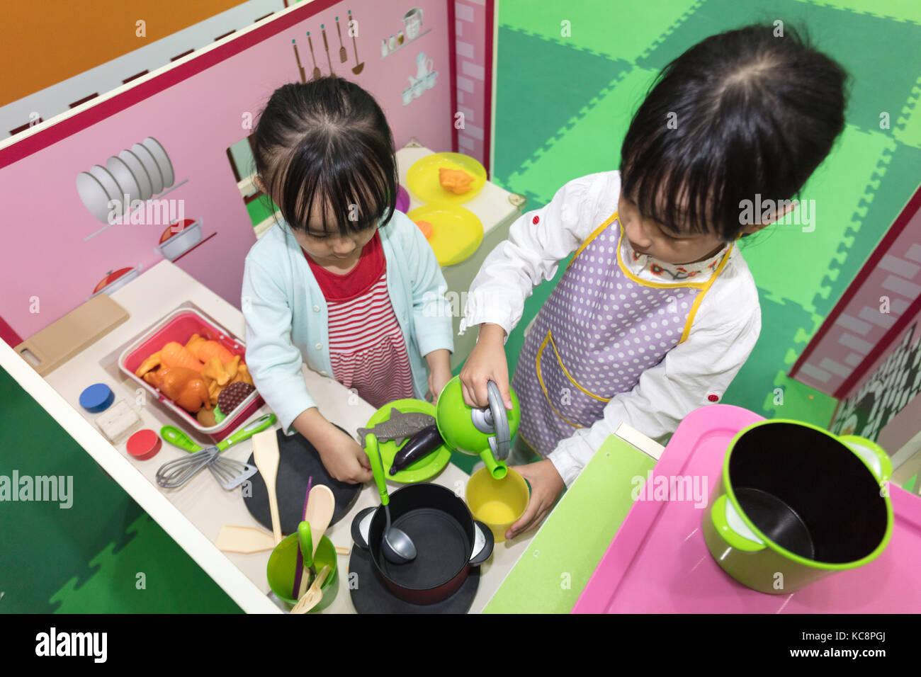 Asian Chinese Little Girls Role Playing At Kitchen At Indoor Playground Stock Photo Alamy