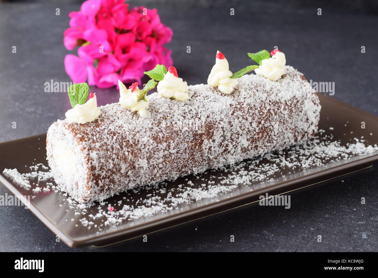 Homemade biscuit roll with coconut filling without baking whole piece Stock Photo
