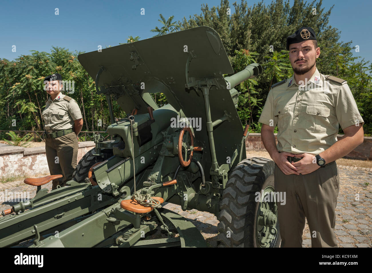 Military personnel pose alongside Rome's noon gun cannon on Janiculum (aka Gianicolo Hill). Stock Photo