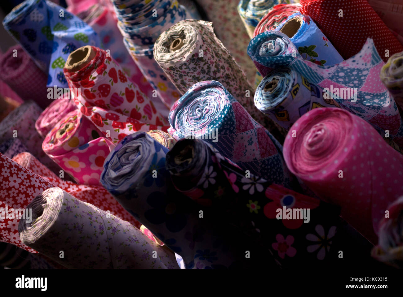 Rolls of cloth at a a market Stock Photo Alamy