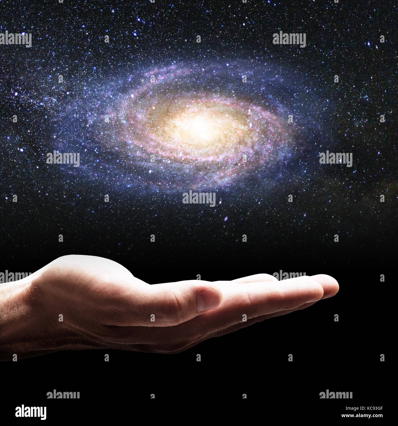 Businessman hand holding little galaxy Stock Photo Alamy
