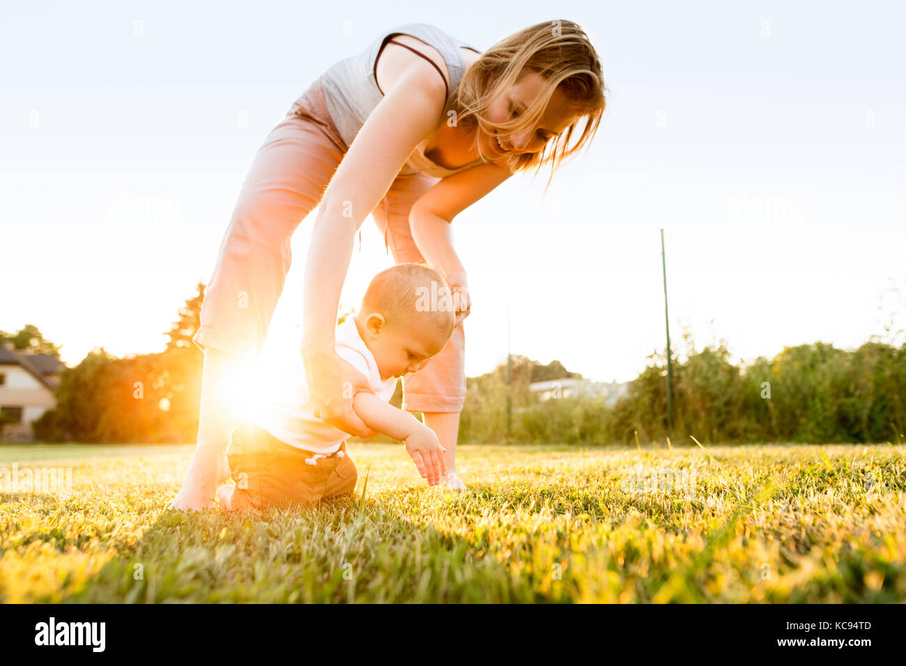 Cute baby boy with his mother outside in the garden. Stock Photo