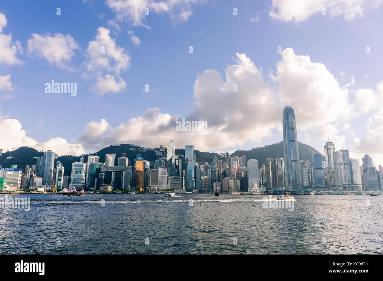 Hong Kong skyline and Victoria Harbour during golden hour before sunset Stock Photo