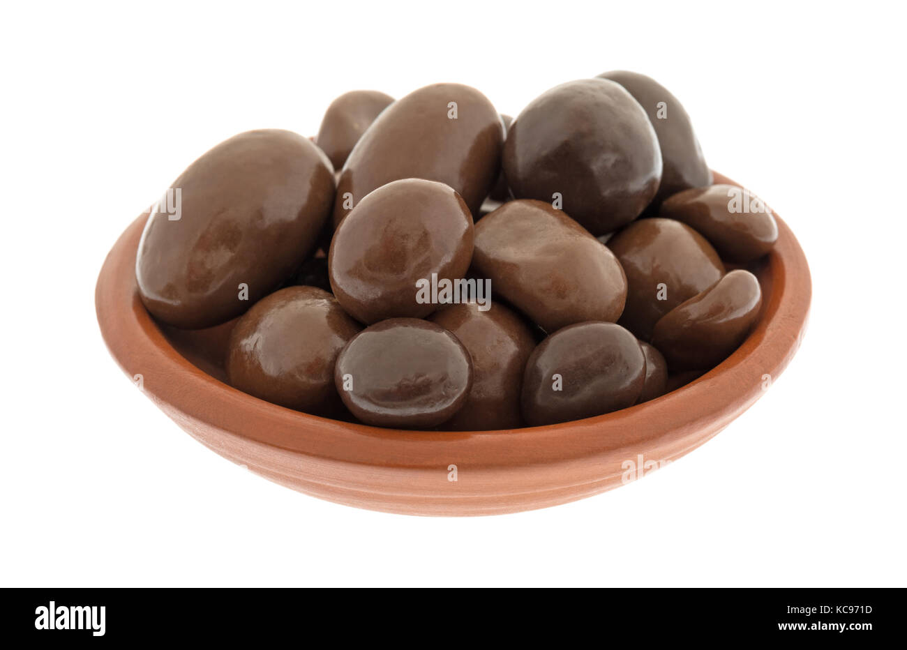 A small bowl filled with bridge mix chocolate candy isolated on a white background. Stock Photo