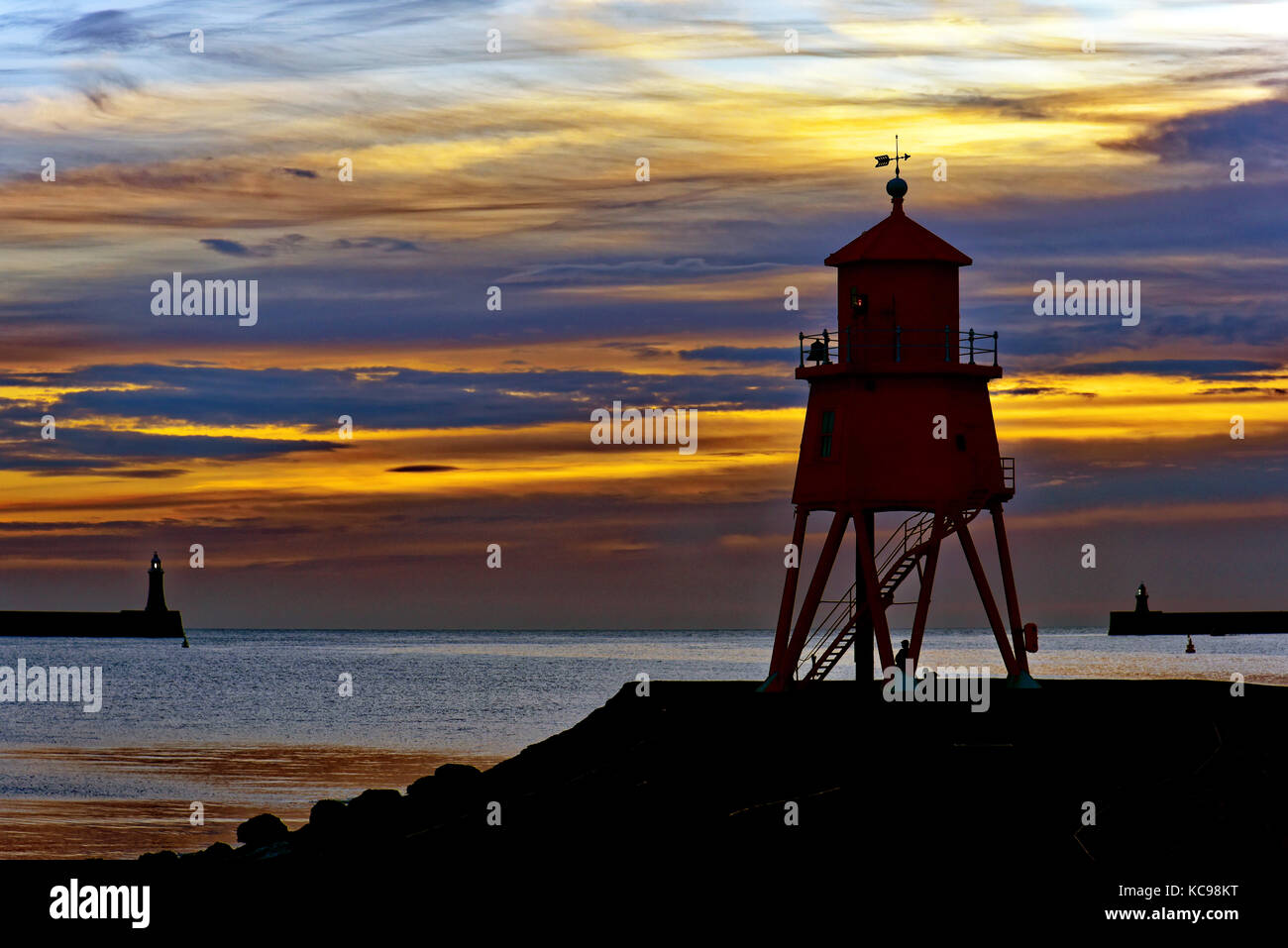 Dawn off the Herd Groyne and North and South pier lighthouses river Tyne South Shields Stock Photo