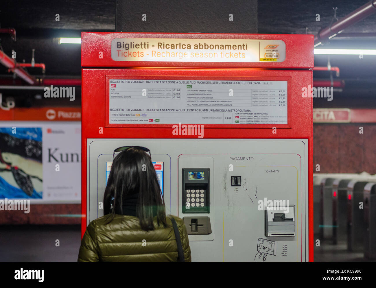 Woman using a ticket machine in the Milan, Italy metro line Stock Photo
