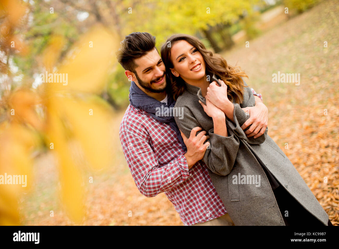 Young couple in love in the autumn forest Stock Photo - Alamy