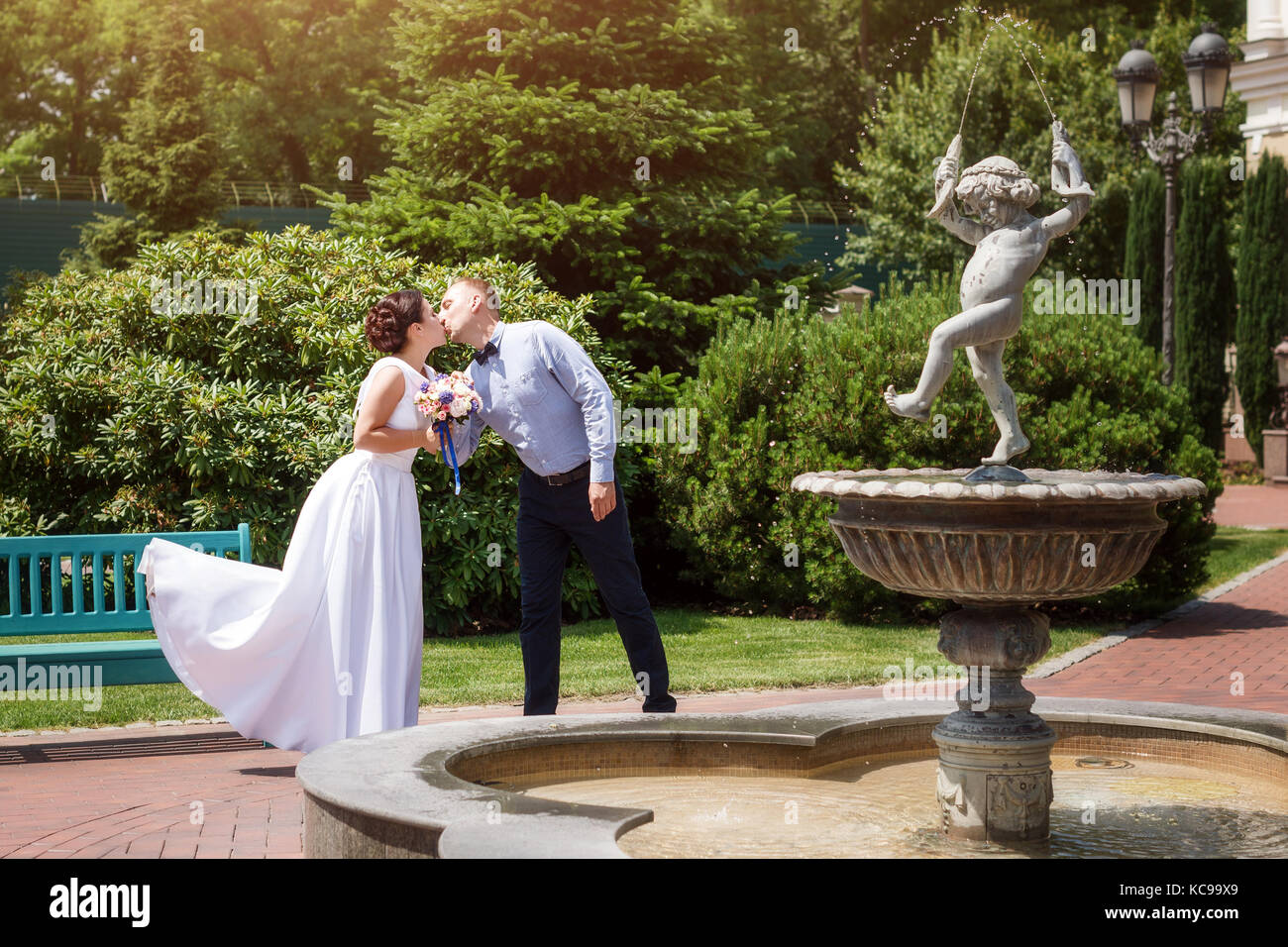 Bride and groom kissing outdoors. Wedding day of happy bridal couple ...