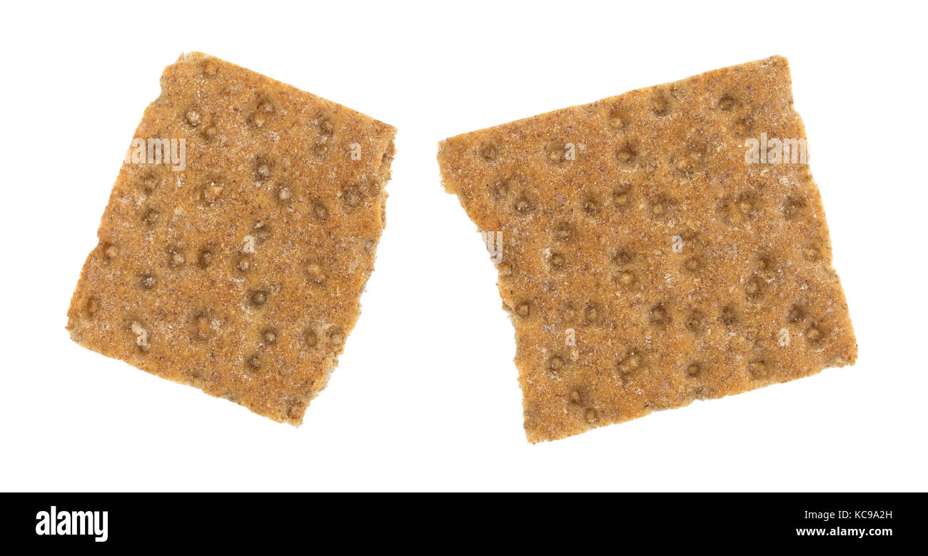 Top view of a broken sourdough whole grain crispbread cracker isolated on a white background