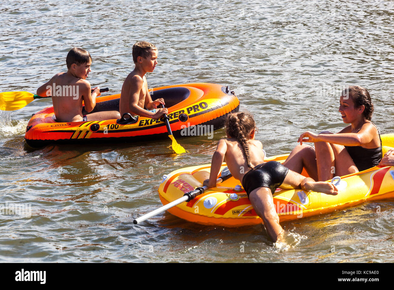 Children in inflatable boats, summer fun on the water, summertime fun Stock Photo