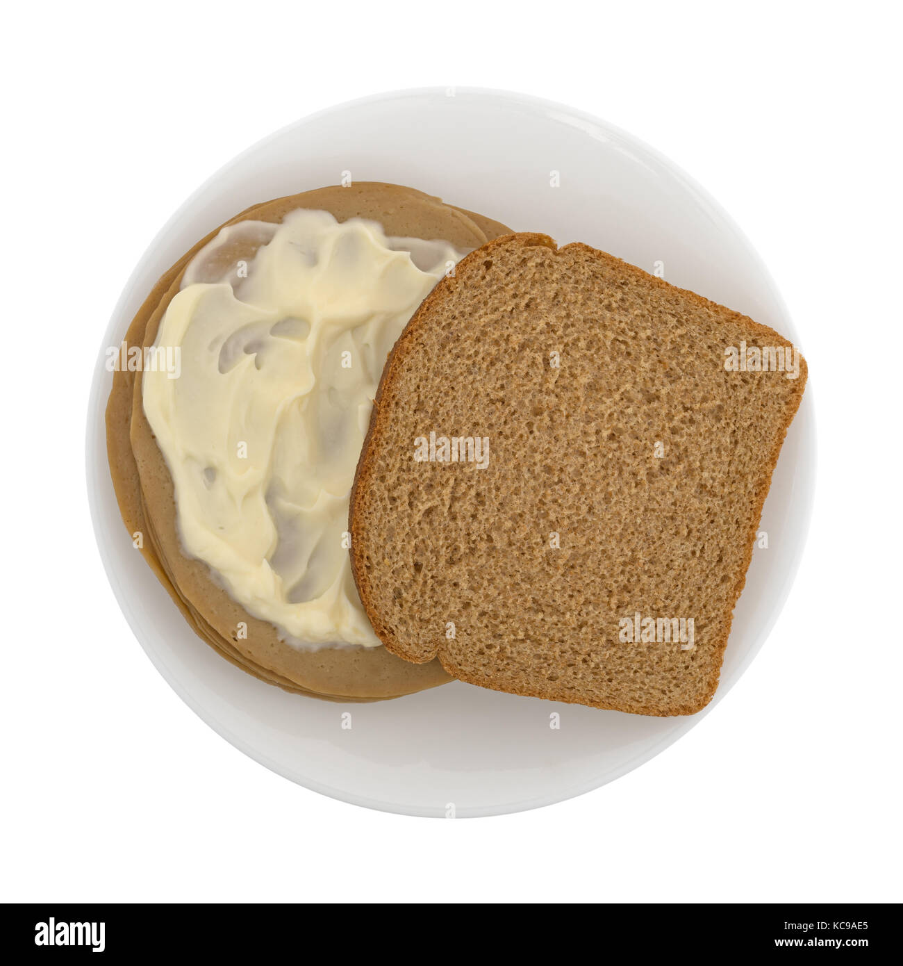 Top view of a tofu turkey slice sandwich on wheat bread with mayonnaise