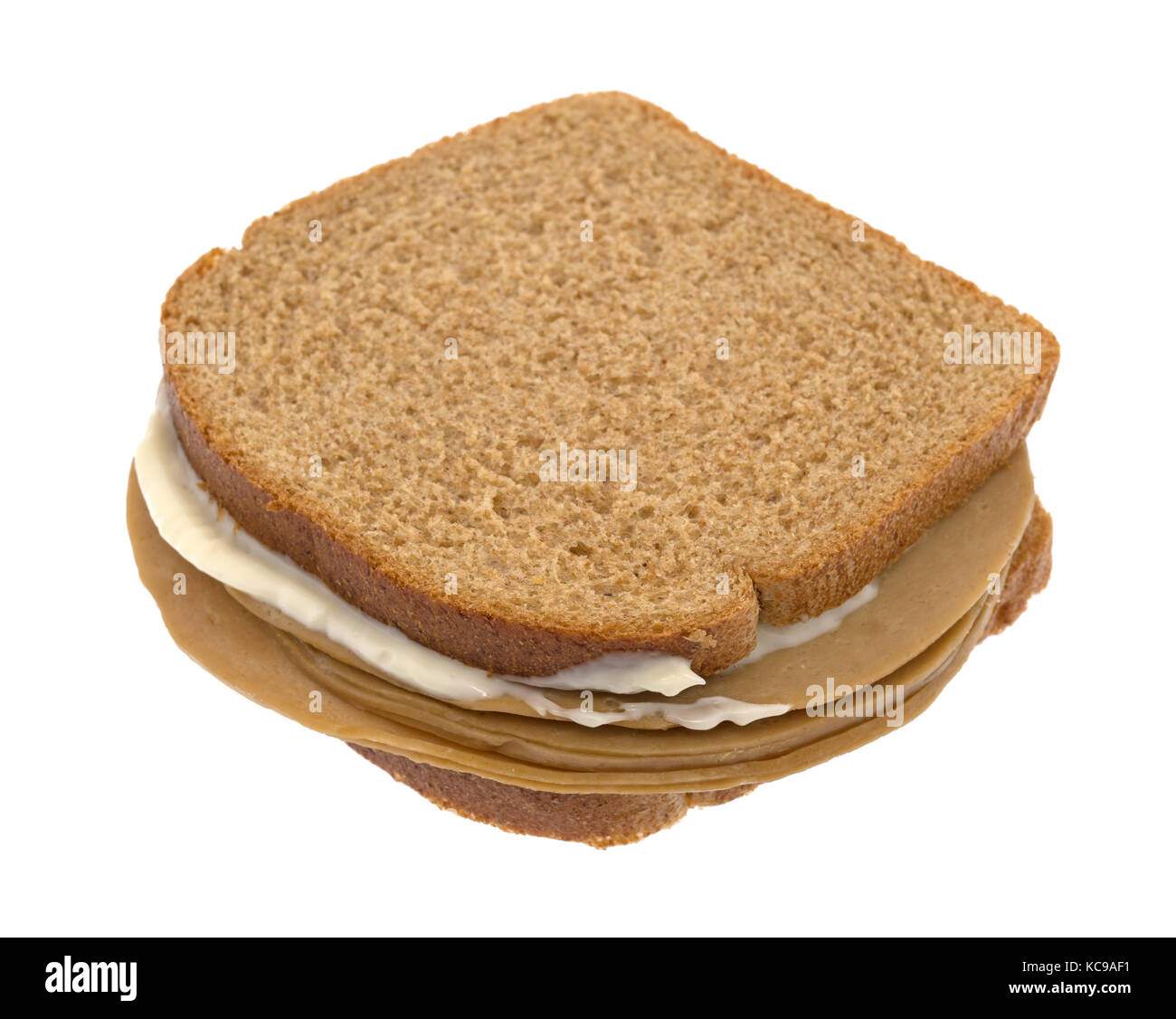 A tofu turkey slice sandwich on wheat bread with mayonnaise isolated on