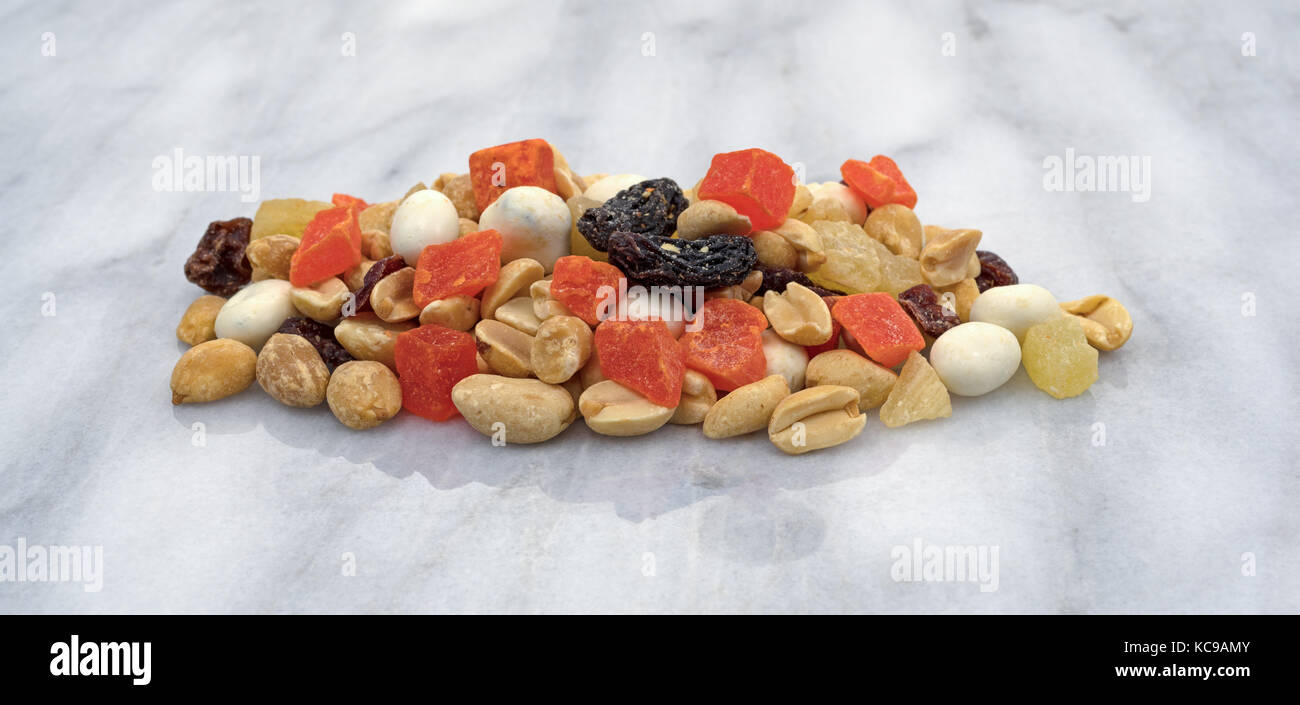 Yogurt covered raisin, fruit and nut trail mix on a gray marble counter