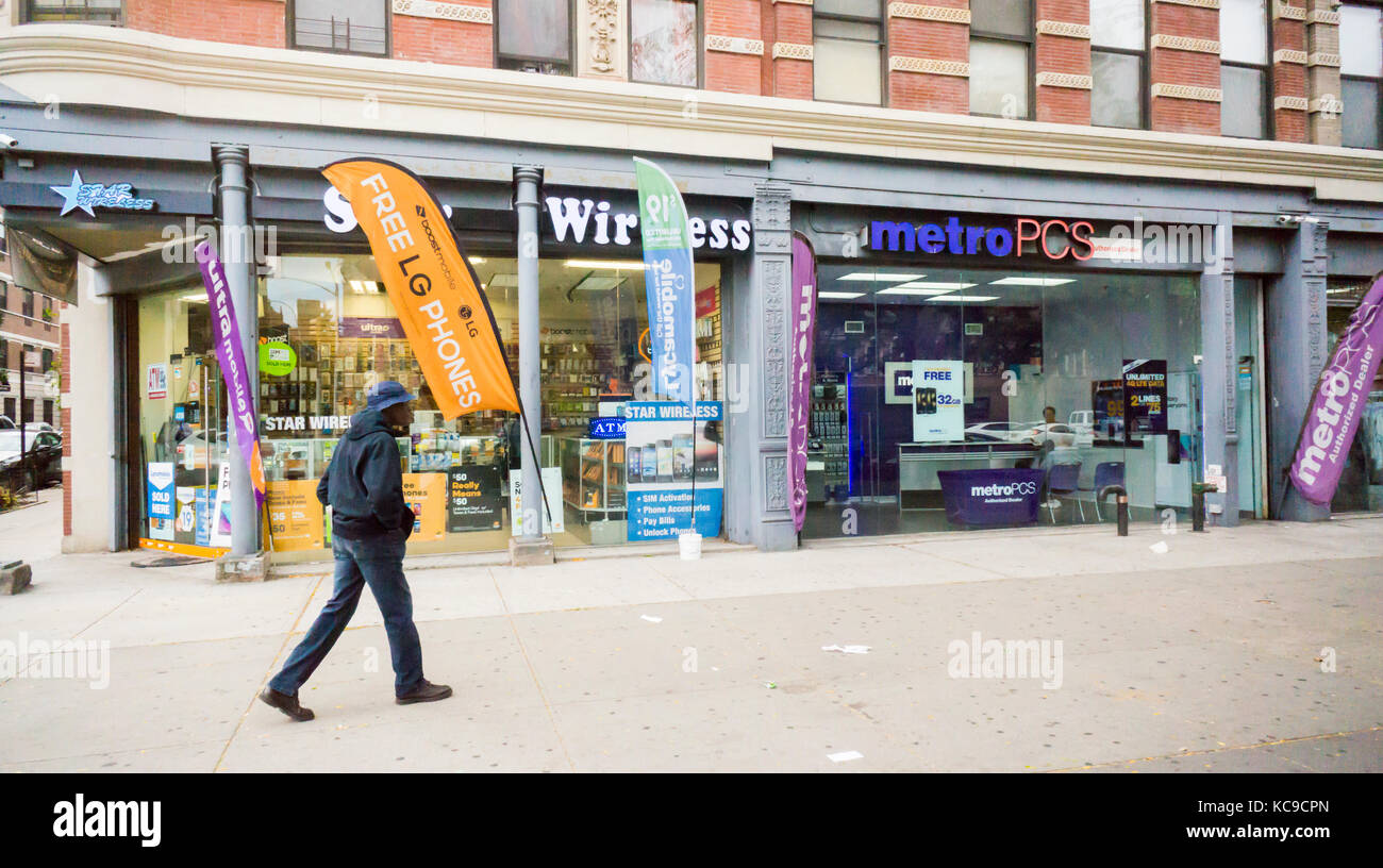 A MetroPCS wireless store next to a store selling services from a number of providers in Harlem in New york on Saturday, September 30, 2017. (© Richard B. Levine) Stock Photo