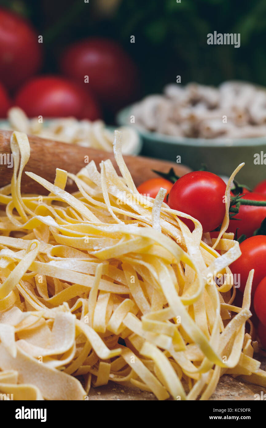 Close-up of unprepared italian pasta with fresh tomatoes Stock Photo