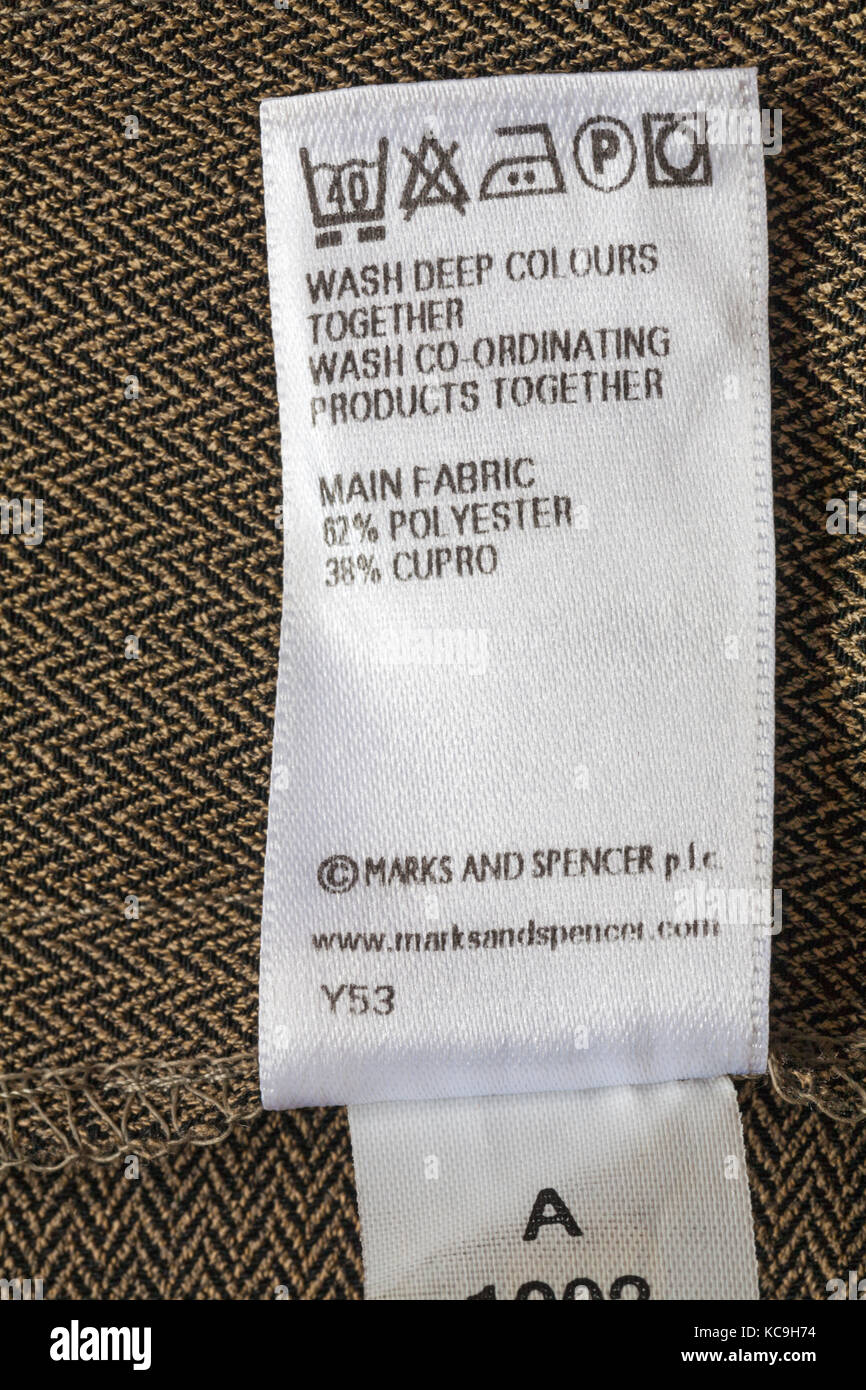 Care washing symbols and instructions on label in Marks and Spencer woman's clothing main fabric 62% polyester 38% cupro Stock Photo