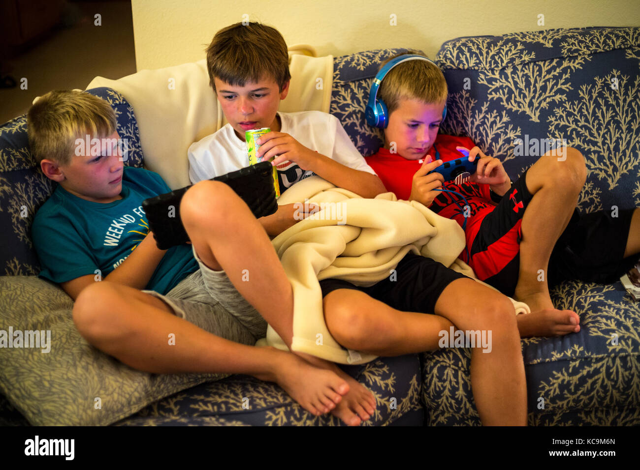 Avon, Outer Banks, North Carolina, USA.  Young American Pre-teenage Boys with their Mobile Gaming Devices. Stock Photo