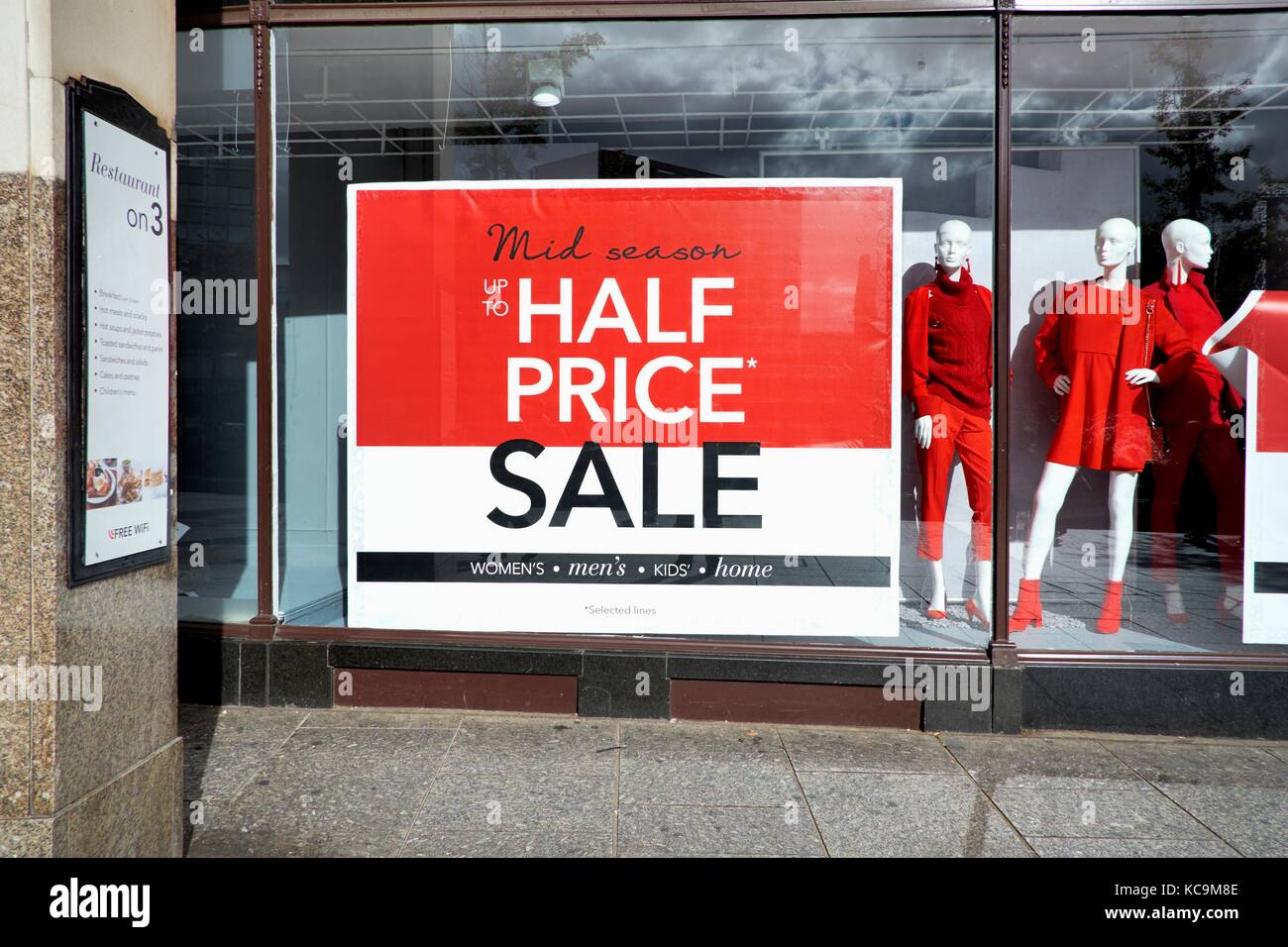 Mid season half price sale shop window uk Stock Photo