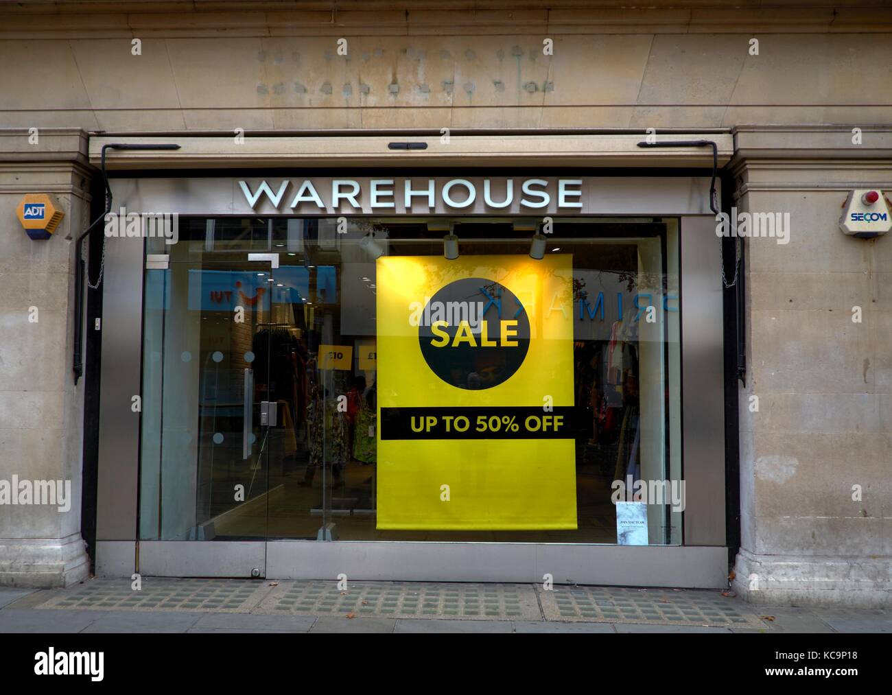 warehouse sale up to 50% off window poster Stock Photo