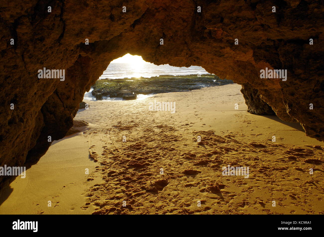 Inside a cliff beach cave during sunset in Albufeira. Algarve, portugal Stock Photo