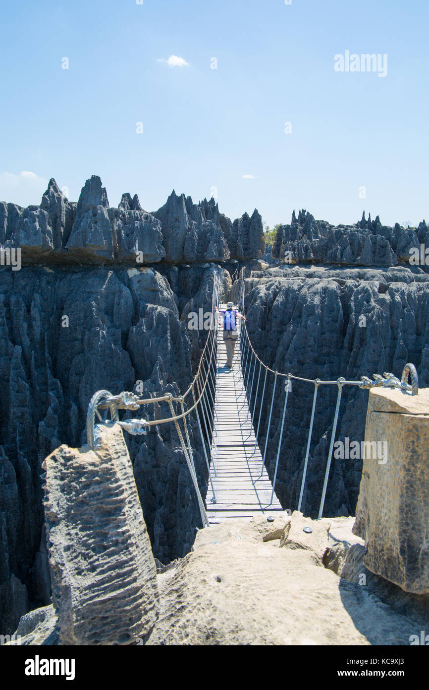 Woman crossing rope bridge across Grand Tsingy, Madagasacar