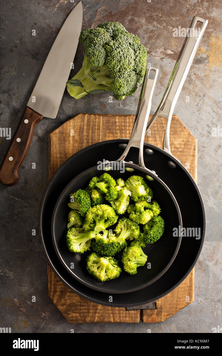 Steamed or stewed broccoli in a skillet Stock Photo