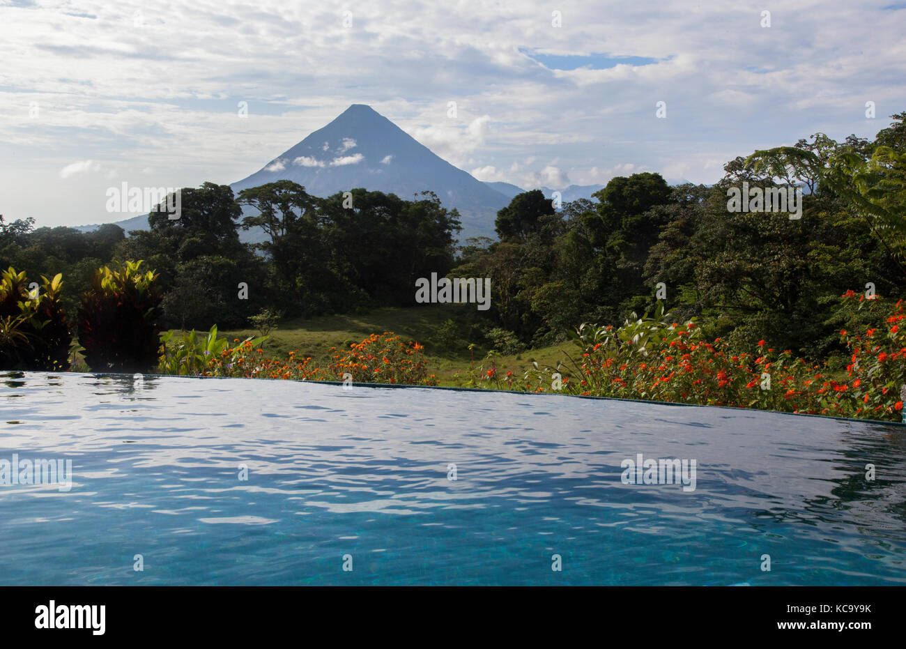 Relax in tropical infinity pool in Arenal Volcano area of Costa Rica Stock Photo