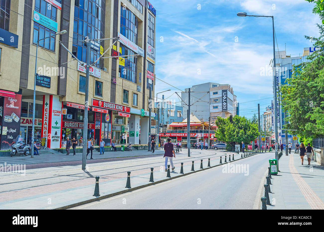 ANTALYA, TURKEY - MAY 12, 2017: The wide avenue in modern district, full of stores, malls and fast food cafes, on May 12 in Antalya. Stock Photo
