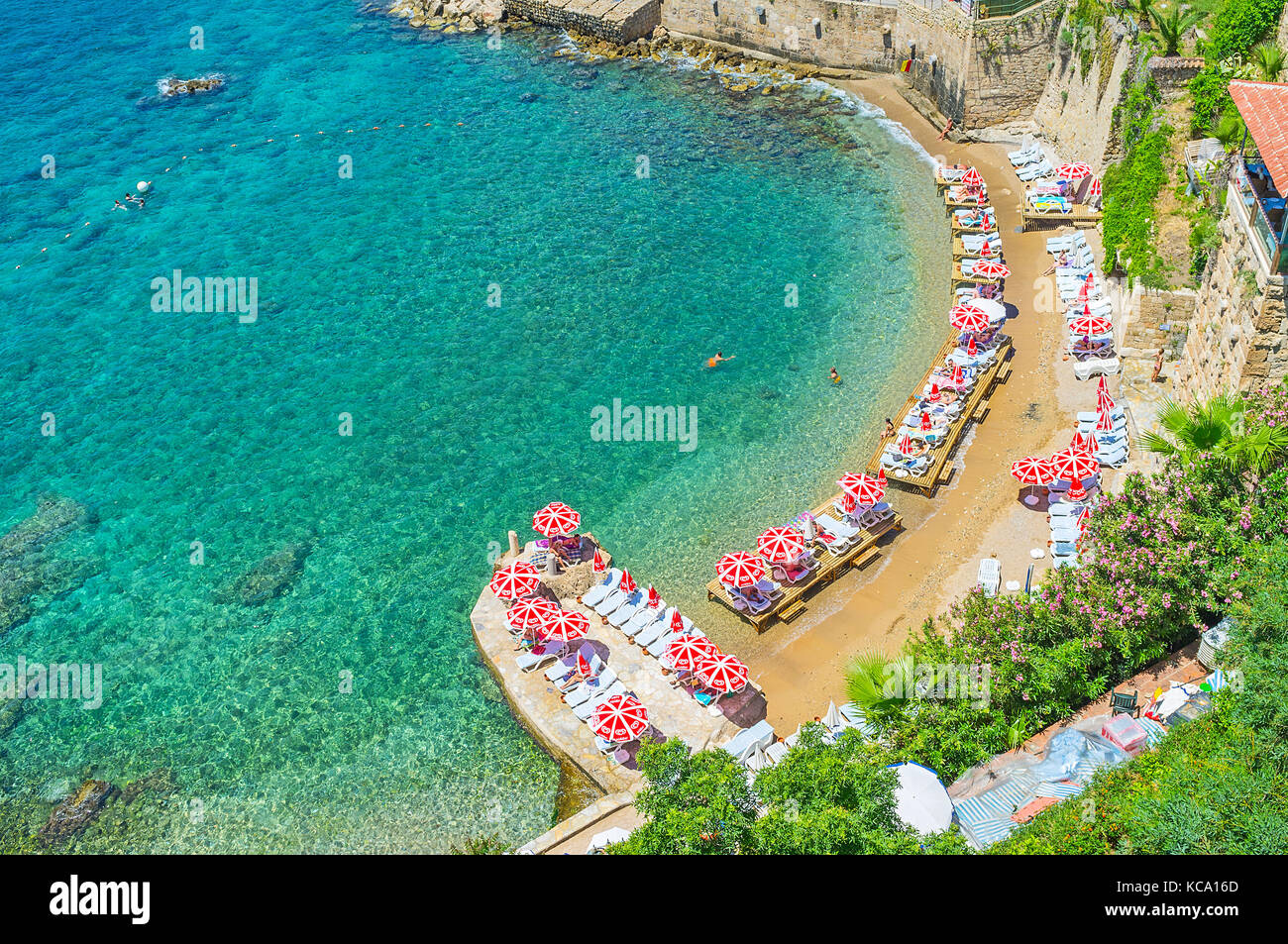 ANTALYA, TURKEY - MAY 12, 2017: Mermerli beach is the best place to relax on chaise-lounge and swim, it's located in historic Kaleici district next to Stock Photo