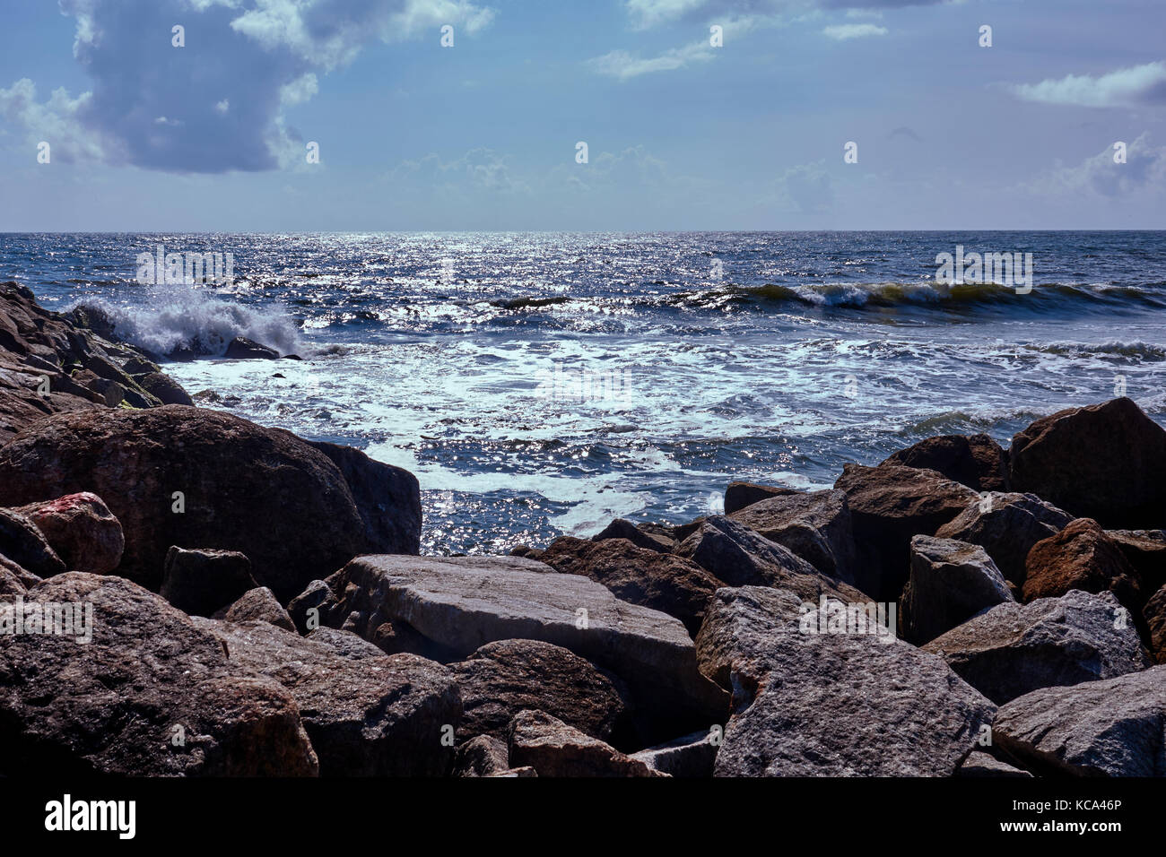 Stone breakwater at a southern India beach against the Arabian Sea Stock Photo