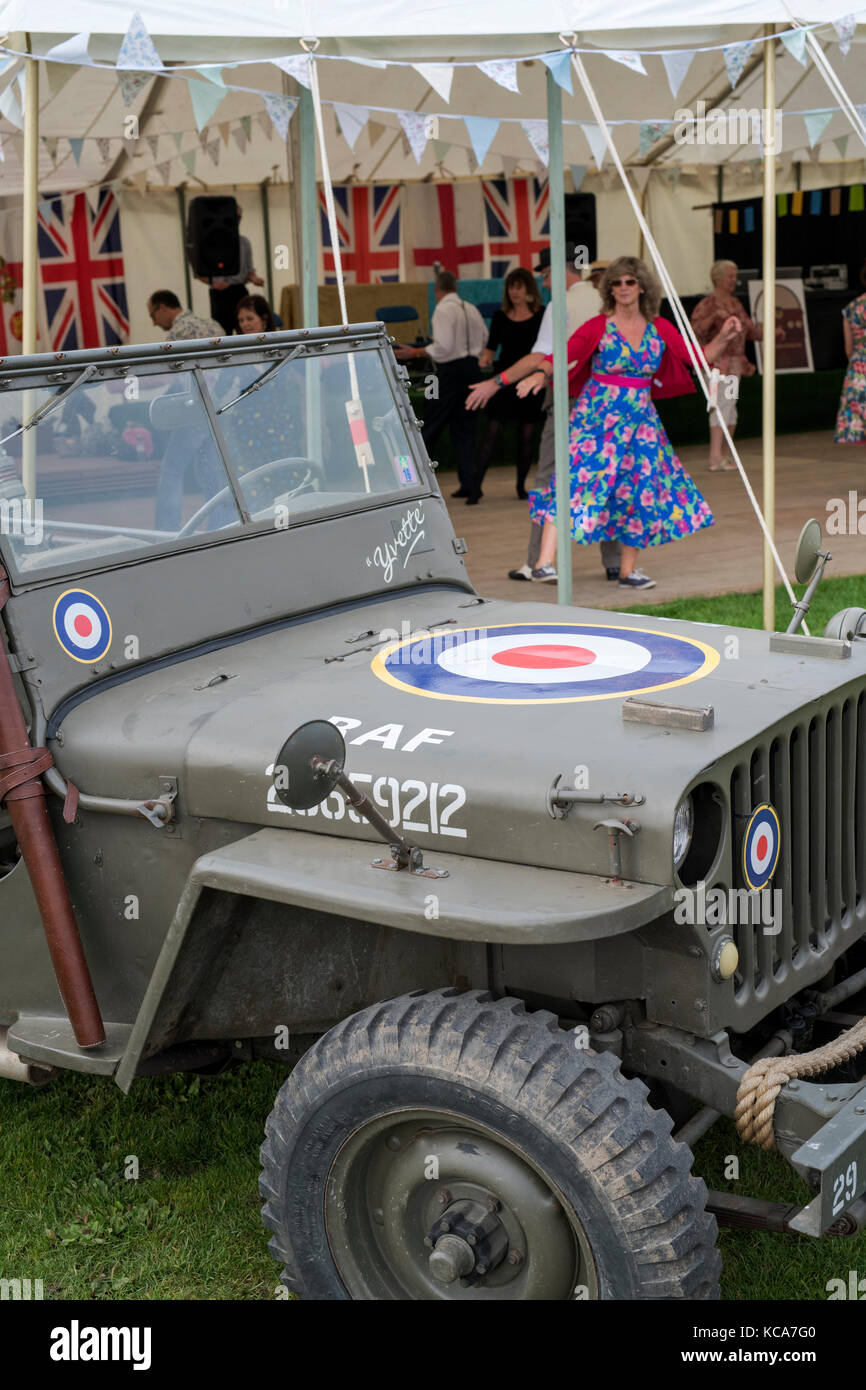 Old RAF Jeep in front of People dancing in the vintage dance tent at Malvern autumn show, Worcestershire, UK Stock Photo