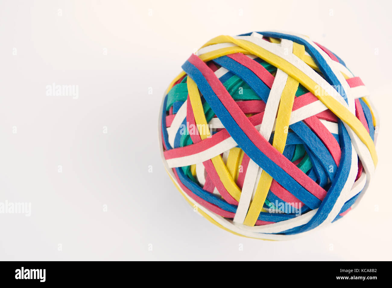 Rubber band ball made from many colourful elastic bands isolated on a