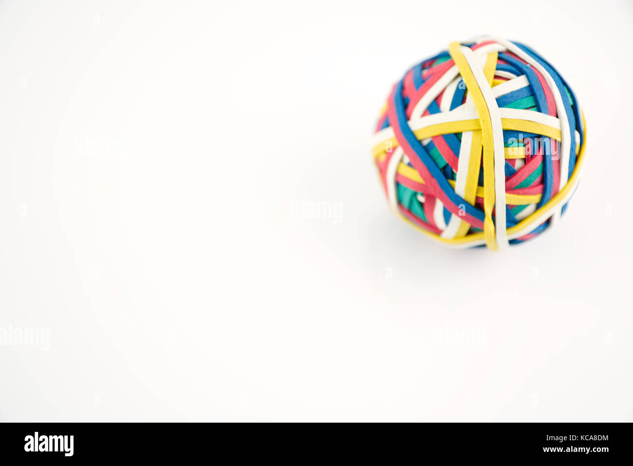 Rubber band ball made from many colourful elastic bands isolated on a