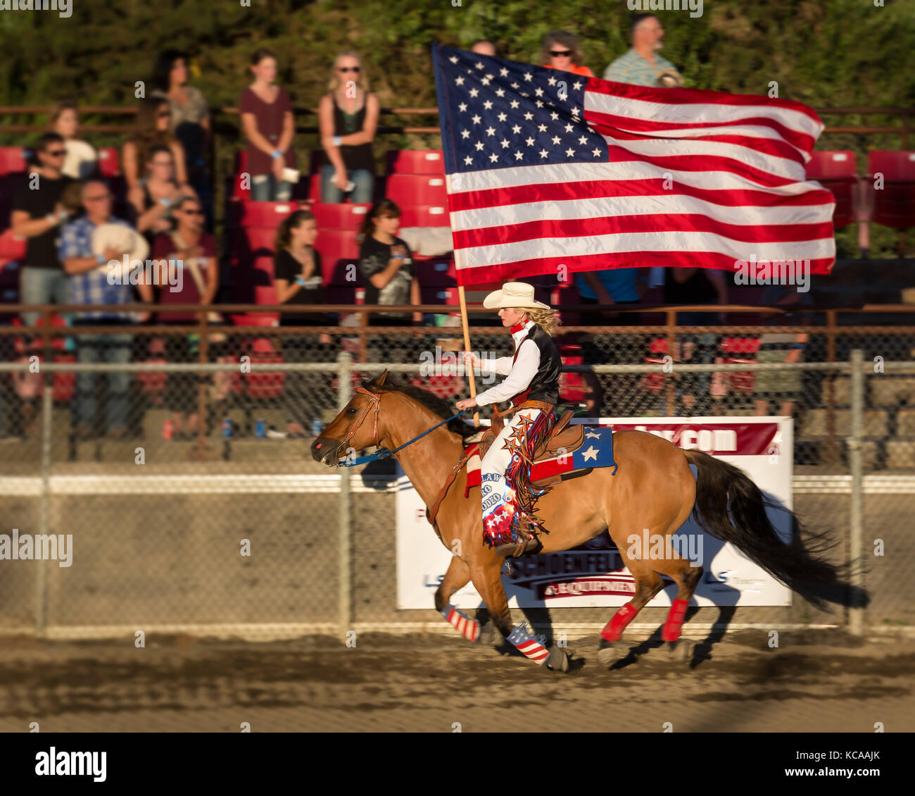 Rodeo Queen riding with the American flag at the Pro Rodeo in Enumclaw,  WA Stock Photo
