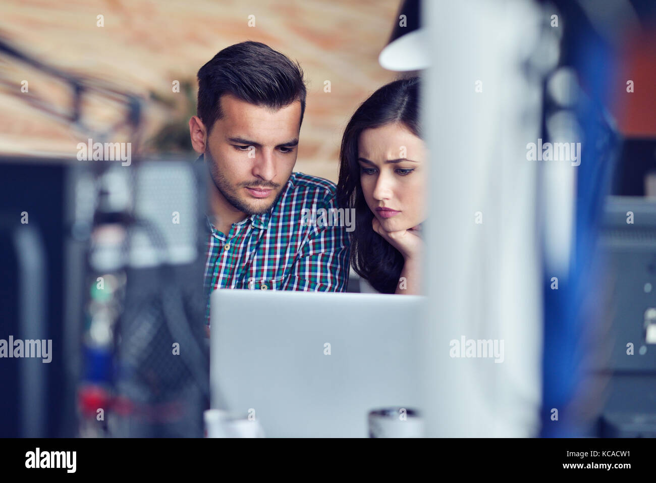 Young Casual business couple using computer in the office. Coworking, Creative manager showing new startup idea Stock Photo