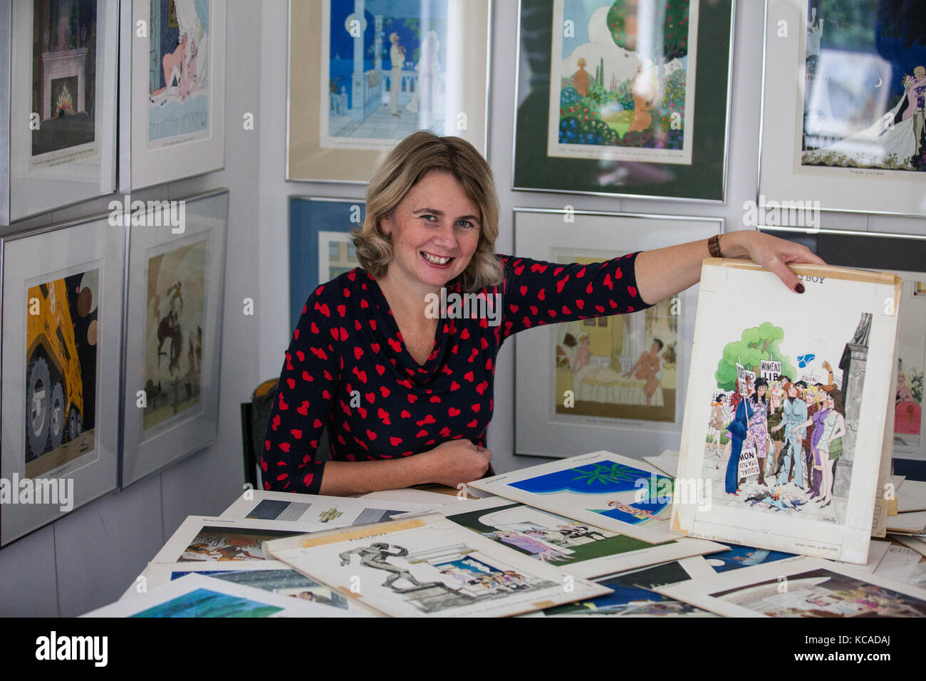 Bromley, UK. 3rd October, 2017. Auctioneer Catherine Southon poses with cartoons by Smilby (Francis Wilford-Smith, 1927-2009), one of the most successful cartoonists of his day and best known for his work for Playboy and Punch. Part 1 of the Smilby Cartoon Collection will be auctioned by Catherine Southon Auctioneers & Valuers on 1st November 2017. Credit: Mark Kerrison/Alamy Live News Stock Photo