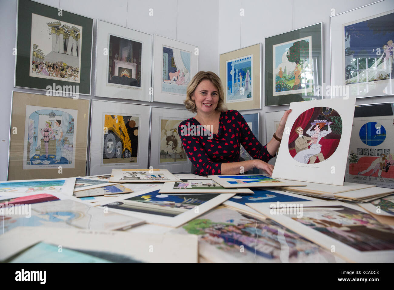 Bromley, UK. 3rd October, 2017. Auctioneer Catherine Southon poses with cartoons by Smilby (Francis Wilford-Smith, 1927-2009), one of the most successful cartoonists of his day and best known for his work for Playboy and Punch. Part 1 of the Smilby Cartoon Collection will be auctioned by Catherine Southon Auctioneers & Valuers on 1st November 2017. Credit: Mark Kerrison/Alamy Live News Stock Photo