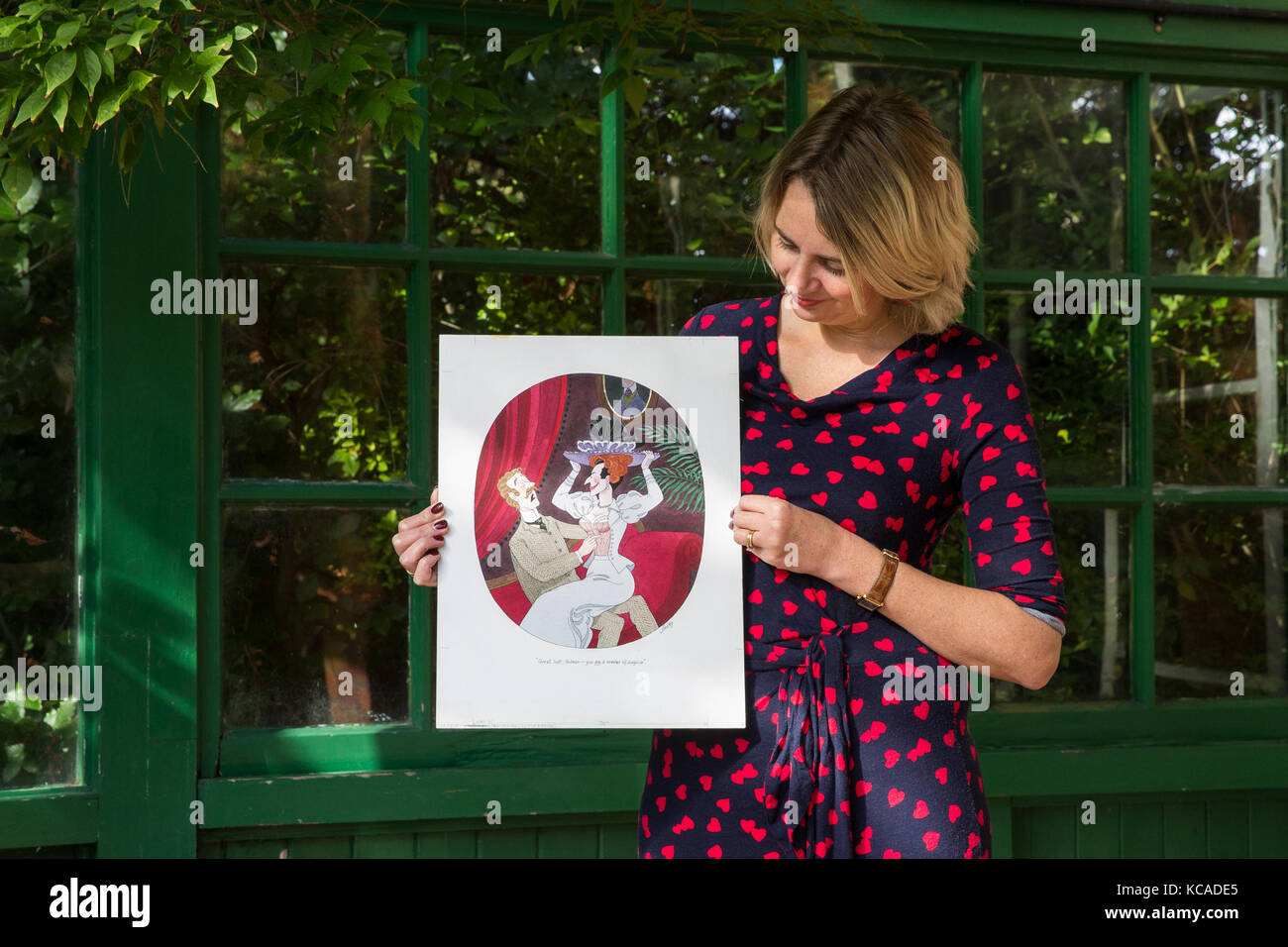 Bromley, UK. 3rd October, 2017. Auctioneer Catherine Southon poses with a cartoon by Smilby (Francis Wilford-Smith, 1927-2009), one of the most successful cartoonists of his day and best known for his work for Playboy and Punch. Part 1 of the Smilby Cartoon Collection will be auctioned by Catherine Southon Auctioneers & Valuers on 1st November 2017. Credit: Mark Kerrison/Alamy Live News Stock Photo