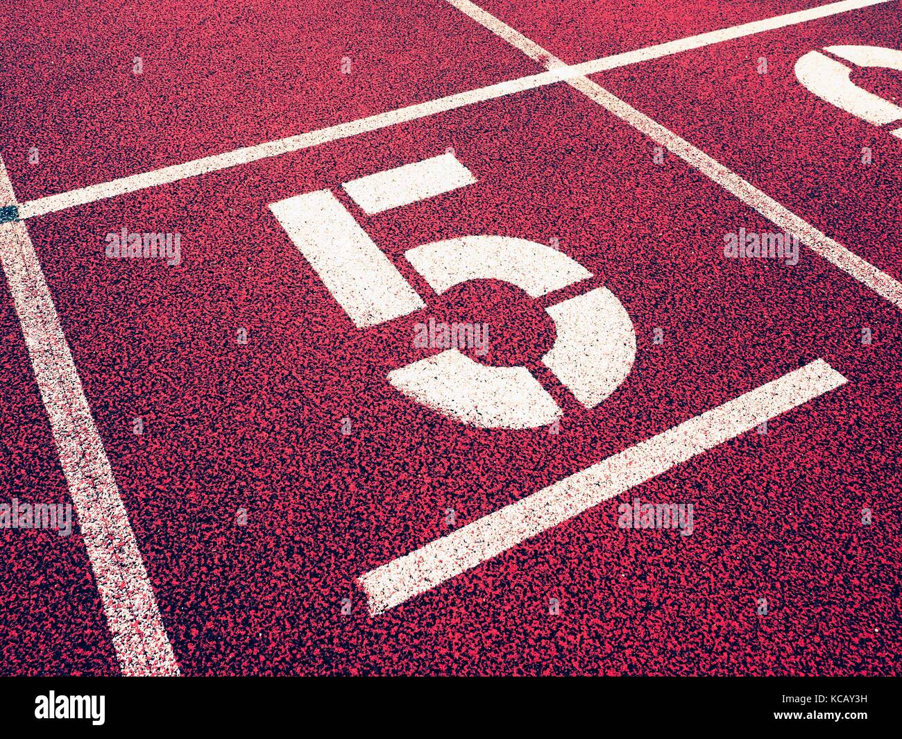 Number five. Big white track number on red rubber racetrack. Gentle ...