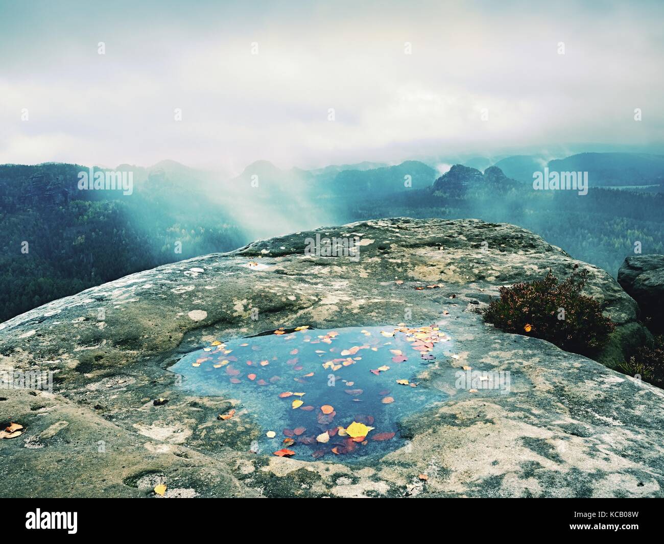 Hilly landscape in water mirror. Misty awakening in mountains after ...