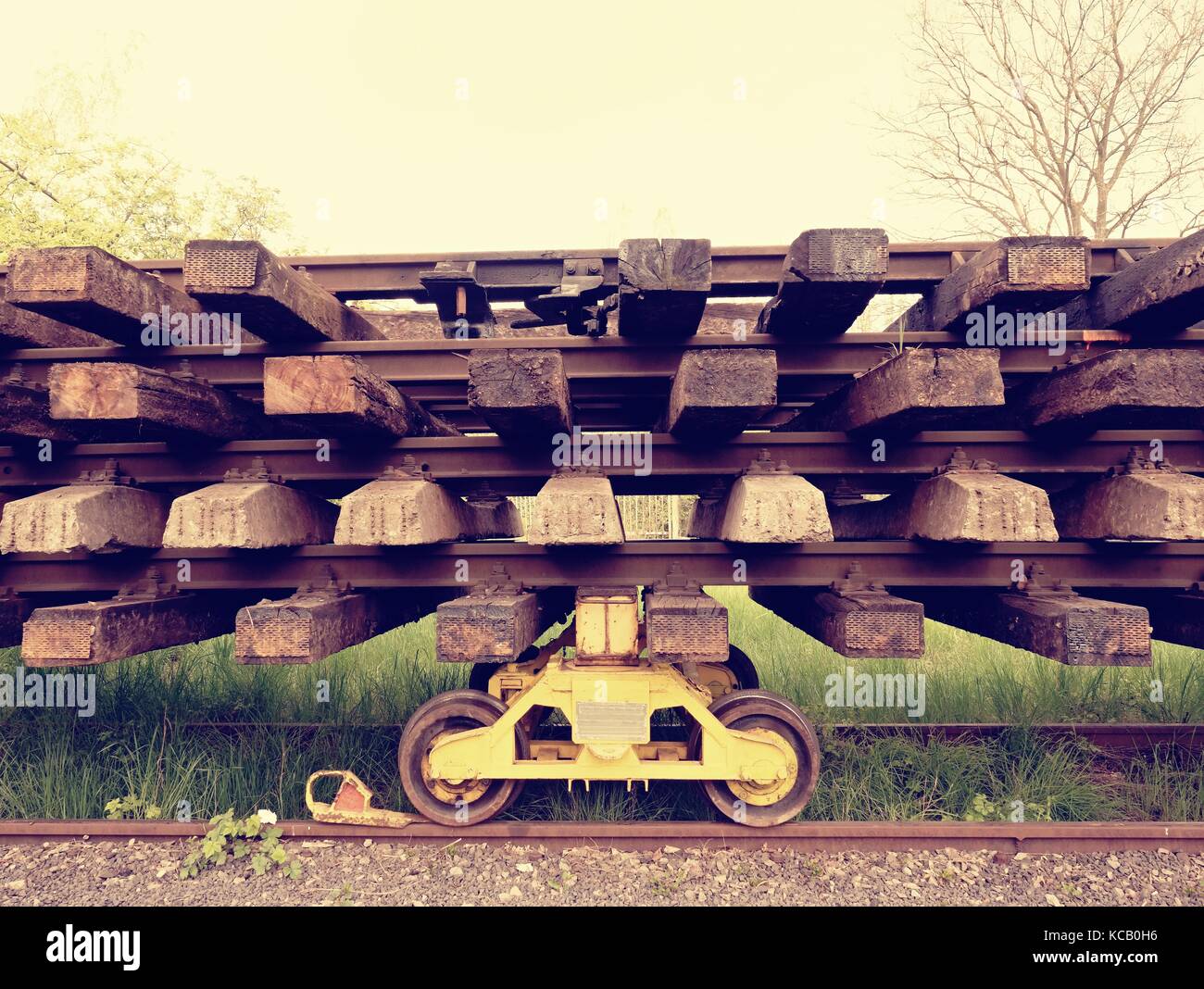 Wagon with extracted old railways. Concrete and wooden sleepers with